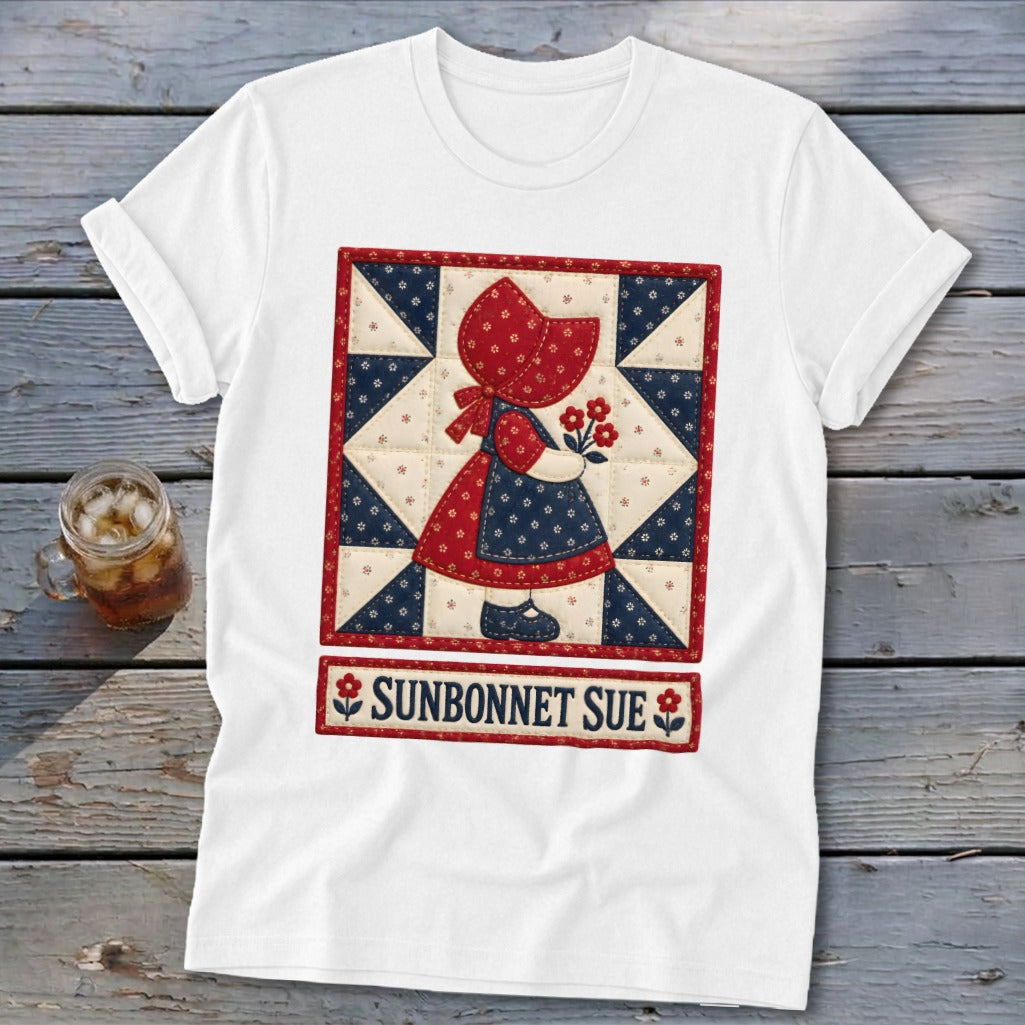 White t-shirt featuring a Sunbonnet Sue quilt design with flowers and text.