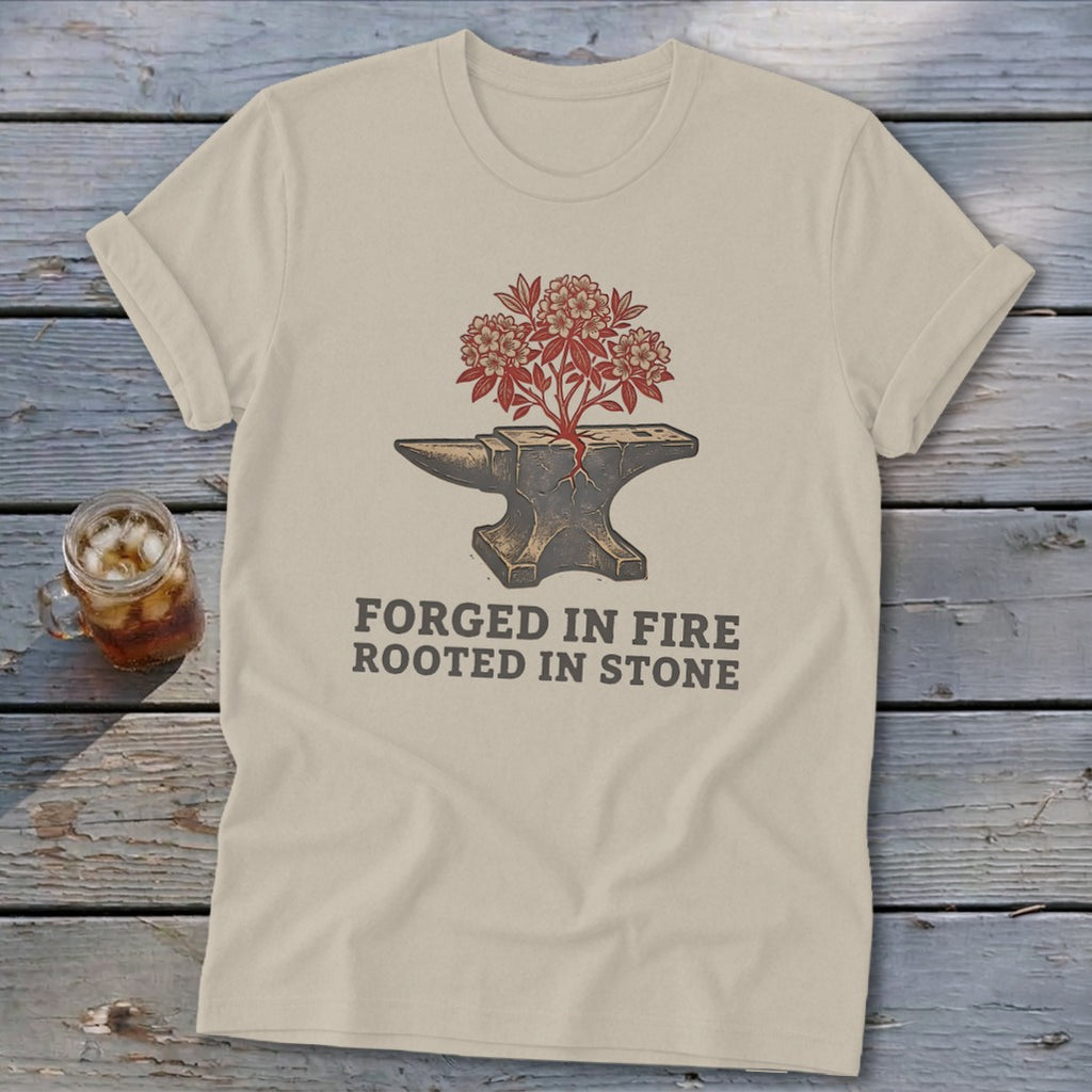 T-shirt with anvil, growing plant, and "Forged in Fire Rooted in Stone" text.