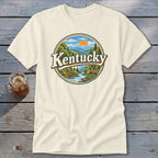 Cream t-shirt with circular graphic of Kentucky landscape featuring deer, river, and mountains.