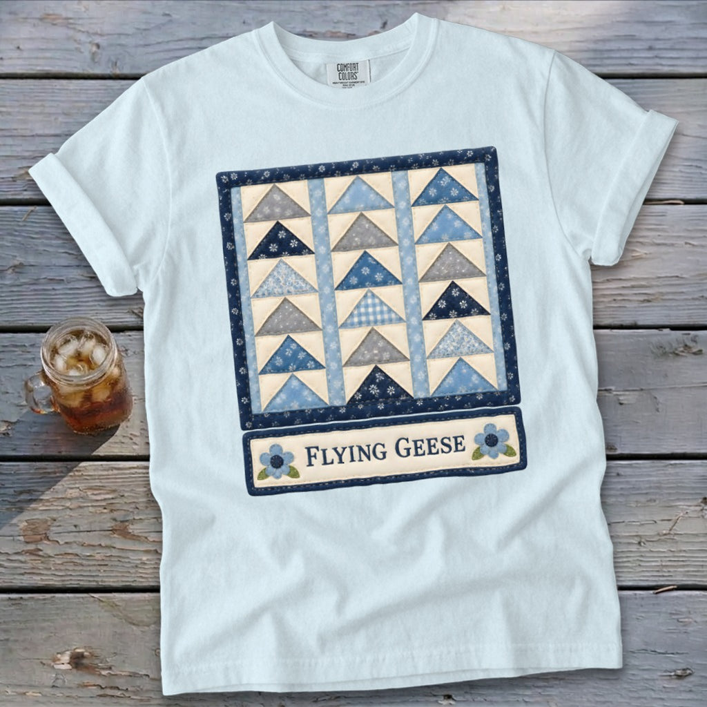 Light blue t-shirt with a "Flying Geese" quilt pattern graphic and text.