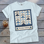 Light blue t-shirt with a "Flying Geese" quilt pattern graphic and text.