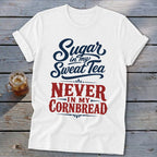 A white t-shirt featuring blue and red text that reads Sugar in my sweet tea never in my cornbread.