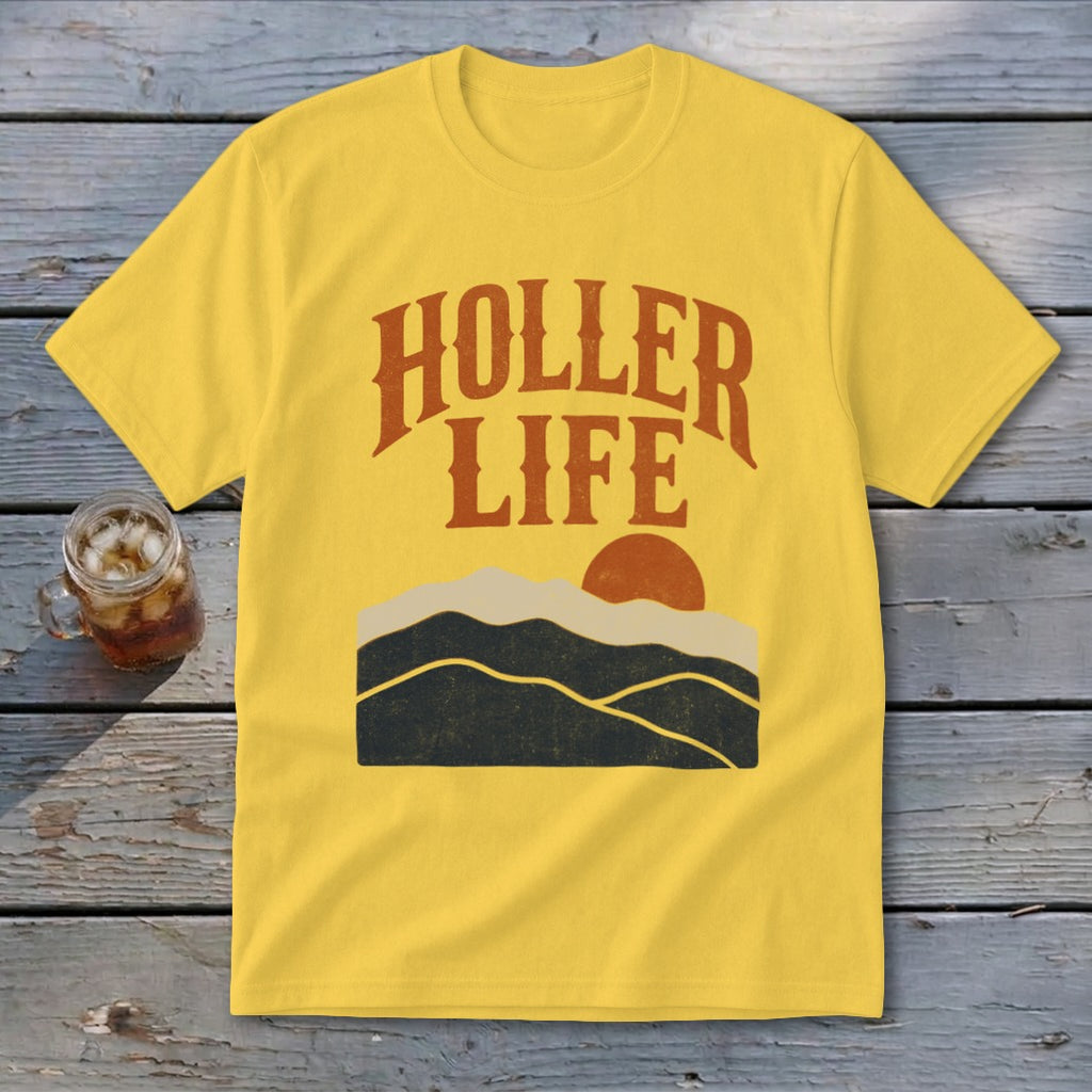 A yellow t-shirt with the orange text "HOLLER LIFE" above a sunset landscape.