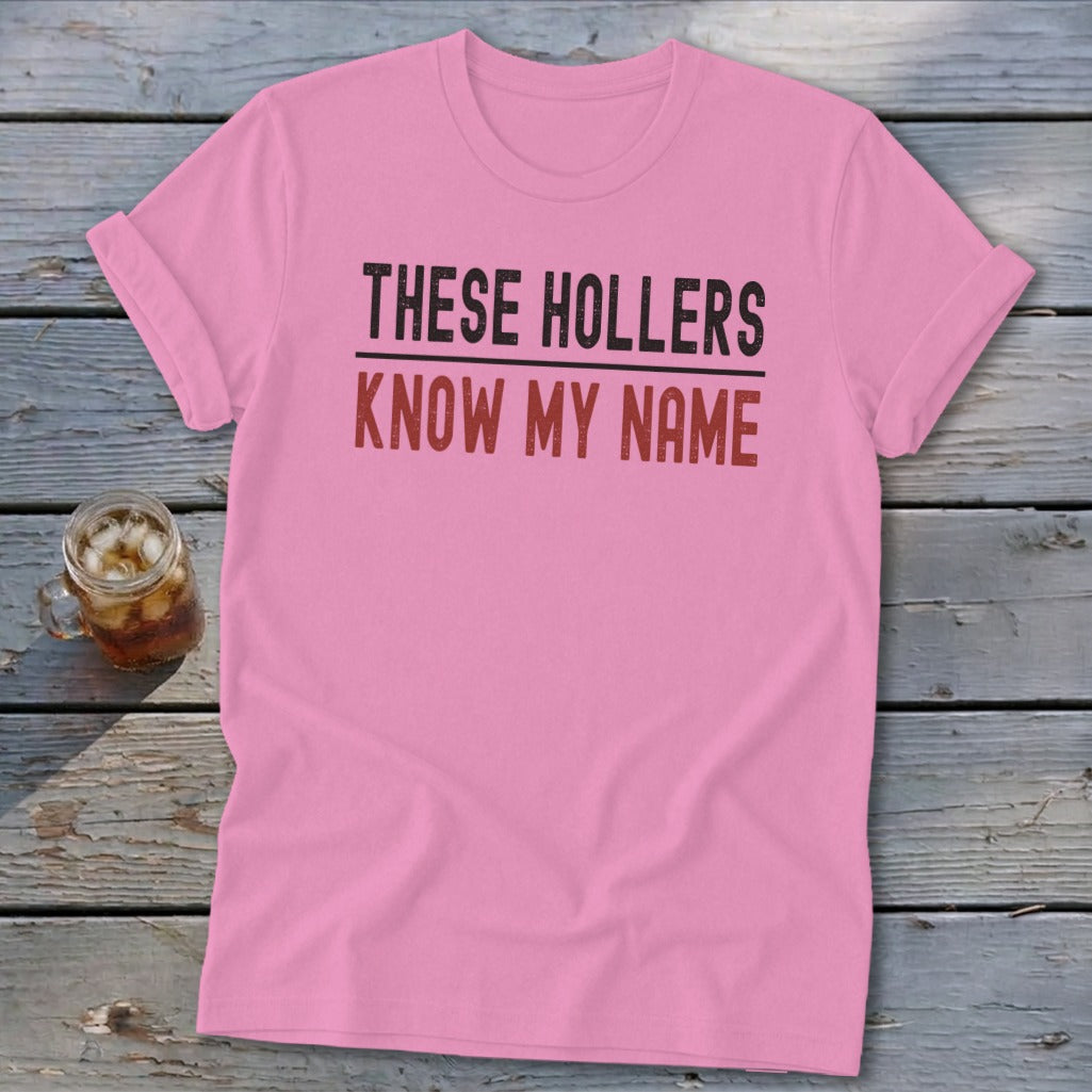 Pink t-shirt with text "THESE HOLLERS KNOW MY NAME"