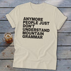 Cream t-shirt with black text "Anymore people just don't understand mountain grammar".