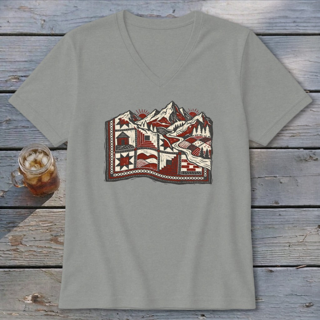 Gray V-neck t-shirt featuring a stylized graphic of mountains integrated with a patterned quilt.
