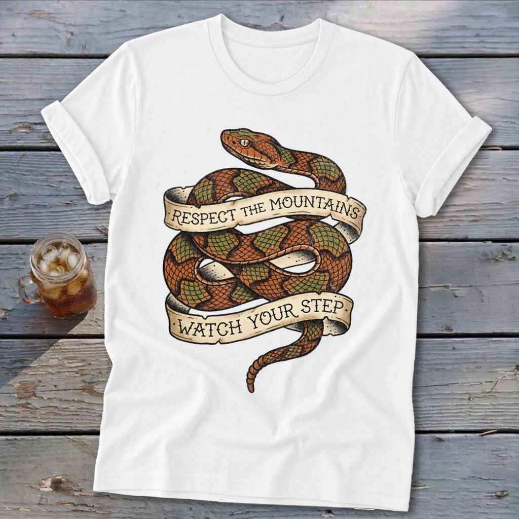 White t-shirt with coiled snake graphic and banner text "Respect the Mountains Watch Your Step".