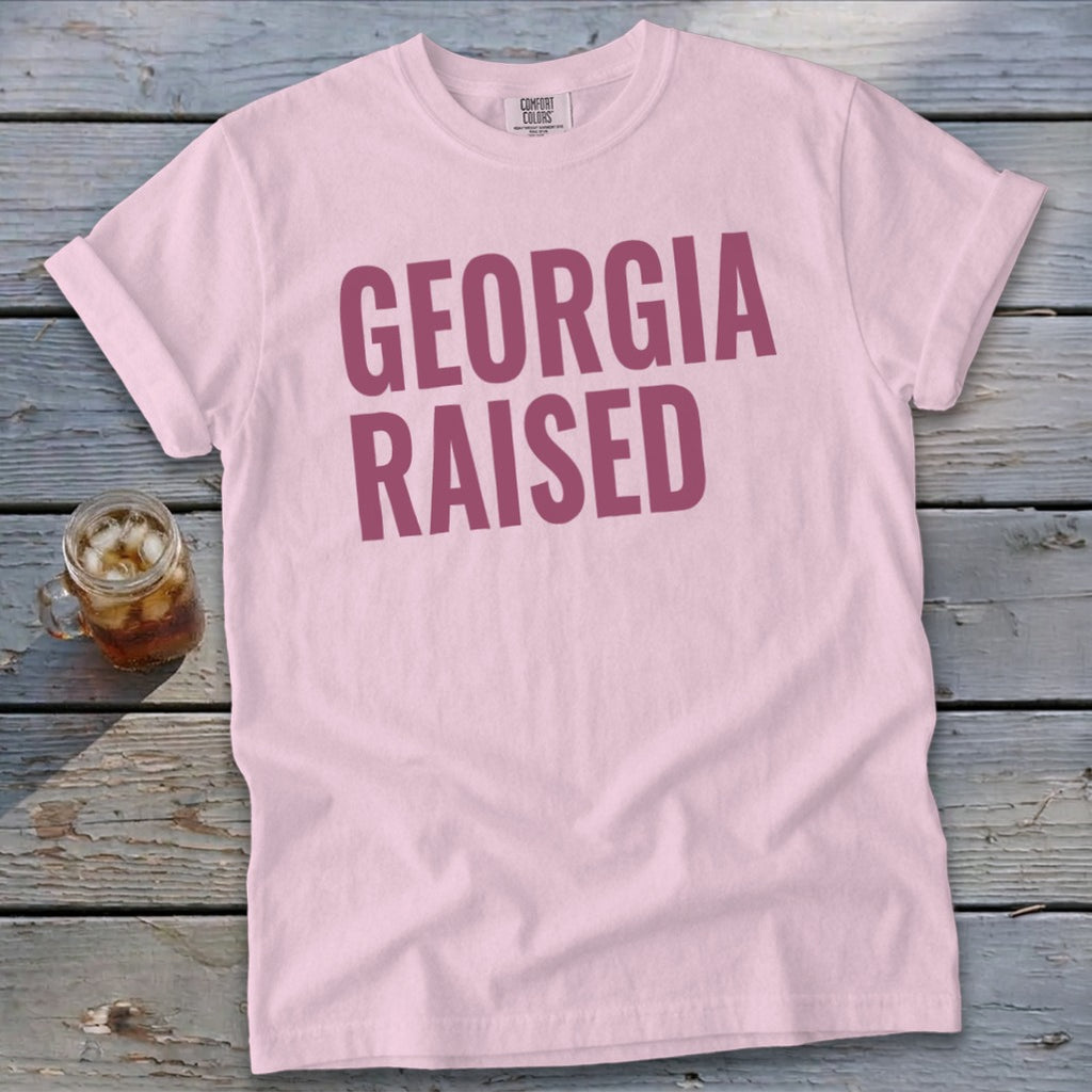 Light pink t-shirt with "GEORGIA RAISED" in maroon text.