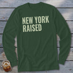 Dark green long-sleeve shirt with "NEW YORK RAISED" in light cream text.