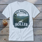 Light blue t-shirt with a graphic featuring a winding road through mountains and text "All Roads Lead to the Holler."