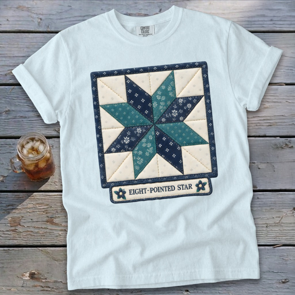 Light blue t-shirt with an eight-pointed star quilt block design.