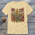 Pale yellow t-shirt with a colorful botanical illustration of autumn flowers and leaves.