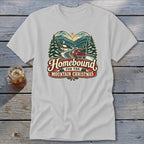 Homebound for the Mountain Christmas graphic on a light gray t-shirt.