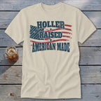 Cream t-shirt with distressed American flag graphic and text "Holler Raised American Made".