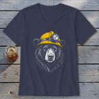 Black bear wearing a yellow hard hat with a headlamp on a dark blue t-shirt.
