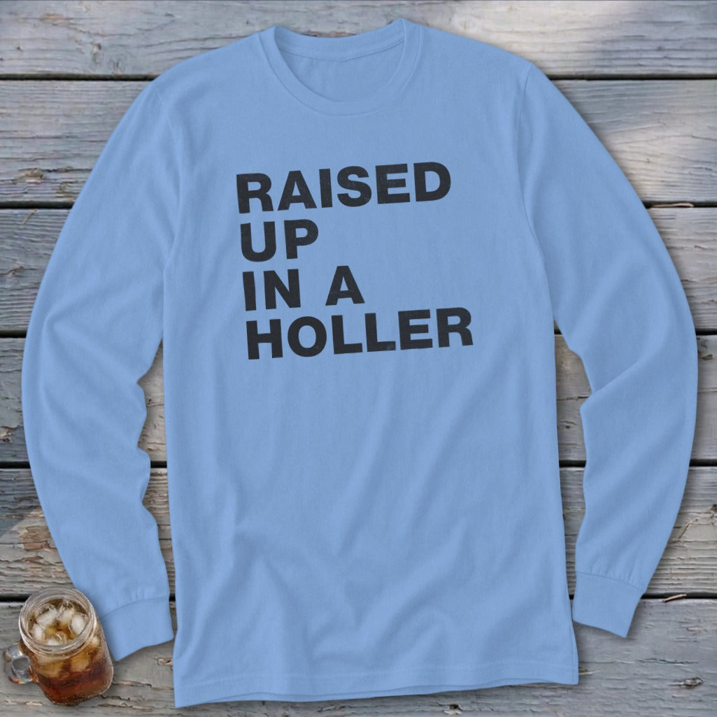 Light blue long-sleeve shirt with black text "RAISED UP IN A HOLLER".