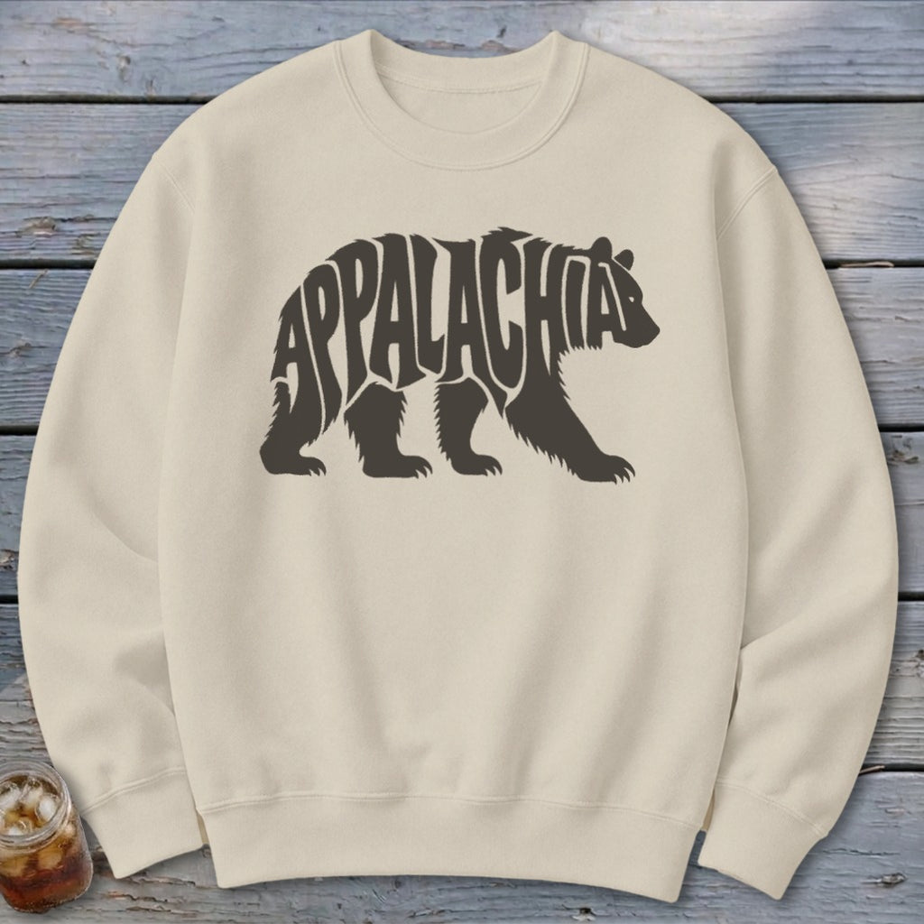 A cream-colored crewneck sweatshirt featuring a dark brown graphic of a walking bear containing the text Appalachia.