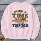 Pink sweatshirt with "Mountain Time Means Whenever We Get There" text and a clock.