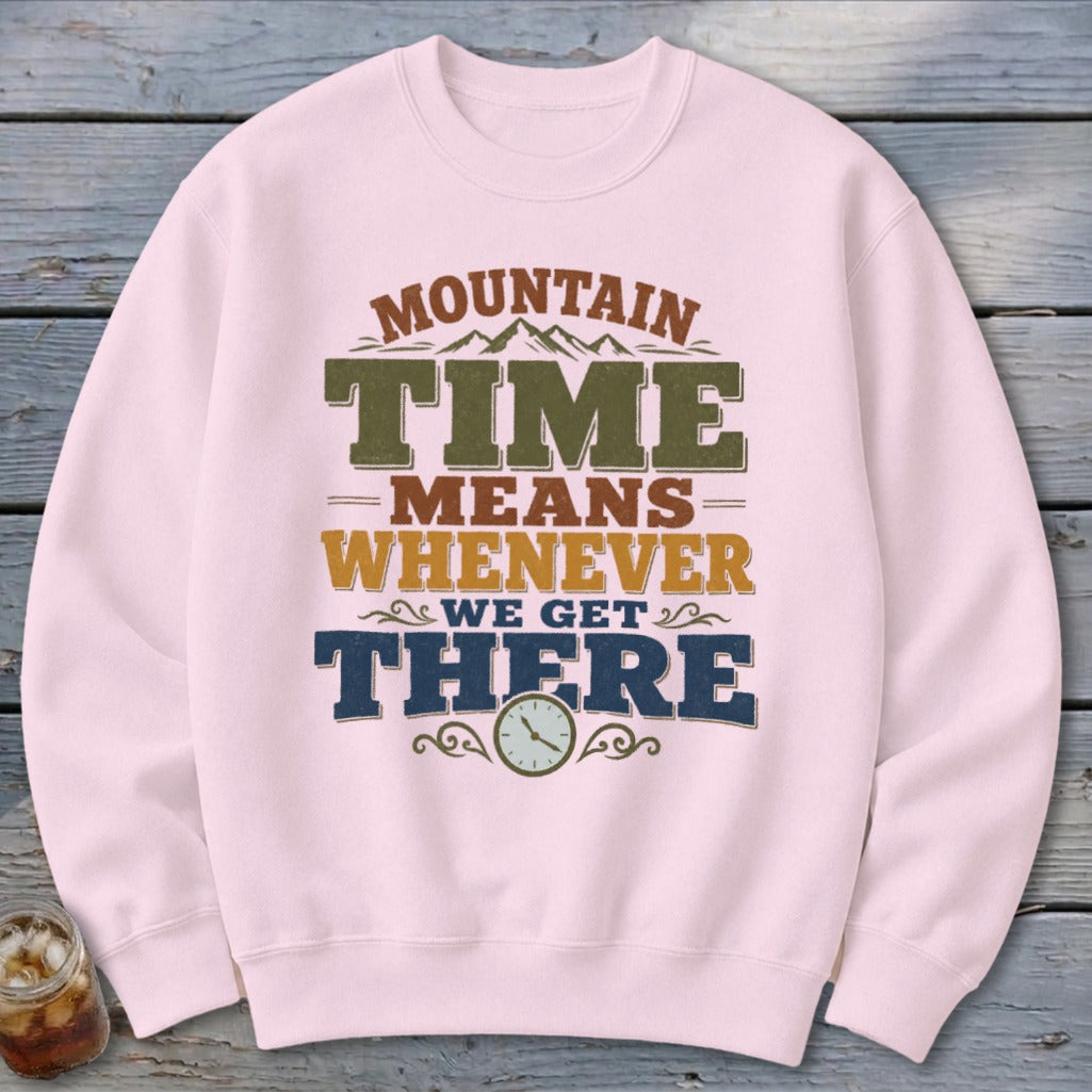 Pink sweatshirt with "Mountain Time Means Whenever We Get There" text and a clock.