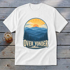 A white short-sleeve t-shirt with a vintage mountain sunset graphic and the text OVER YONDER.