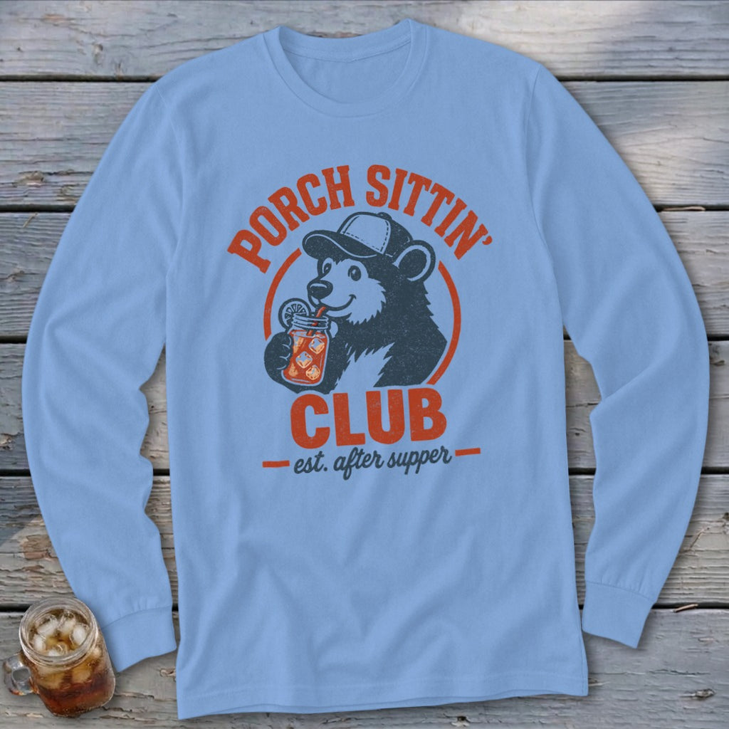 Light blue long-sleeve shirt with a bear drinking a beverage and text "Porch Sittin' Club".