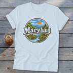 White t-shirt with circular Maryland landscape graphic featuring mountains, trees, river, and deer.