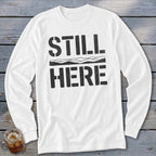 White long-sleeve shirt with "STILL HERE" text and mountain graphic.