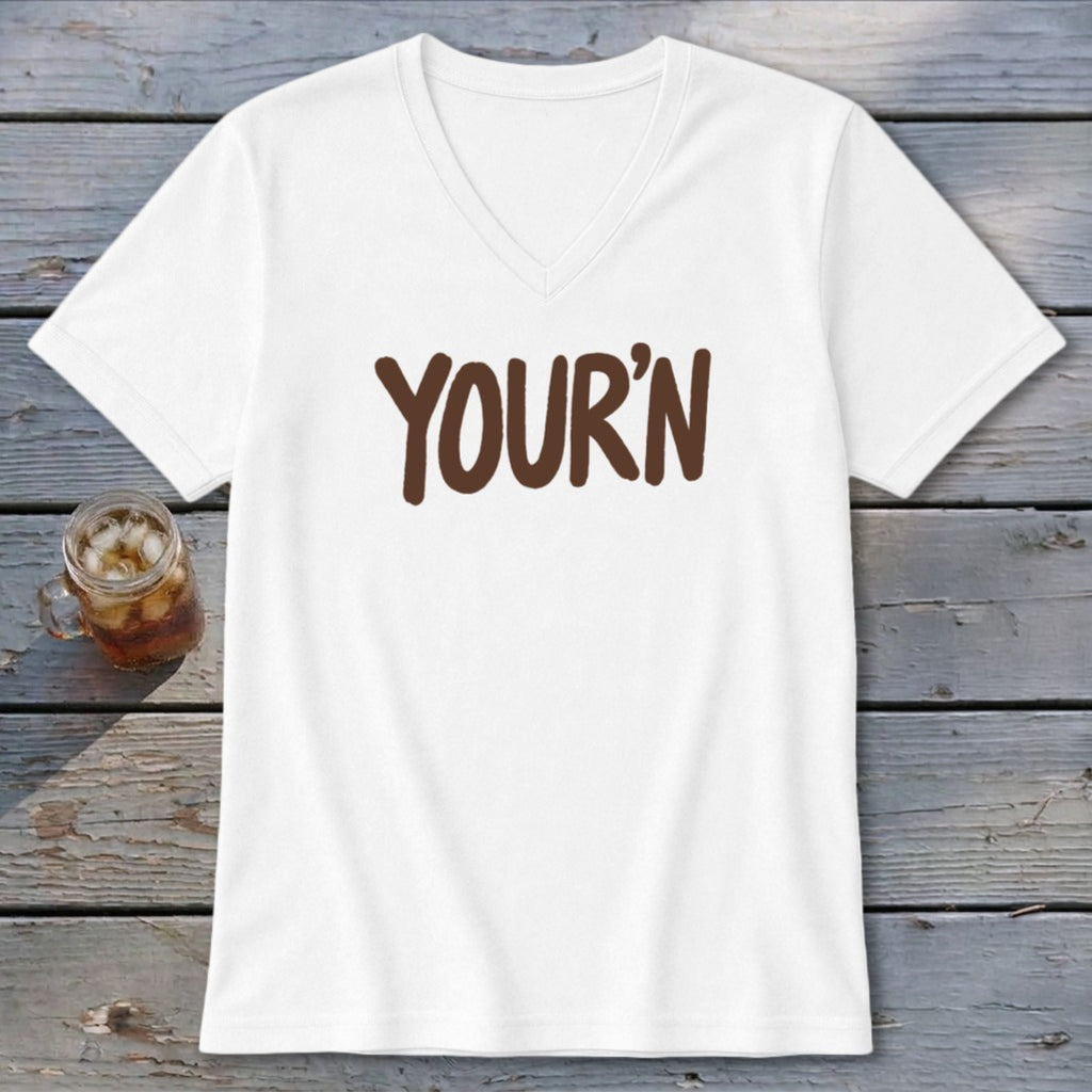 White v-neck t-shirt with brown text "YOUR'N" and a glass of iced tea.