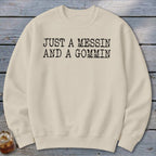 Cream sweatshirt with black text reading "JUST A MESSIN AND A GOMMIN".