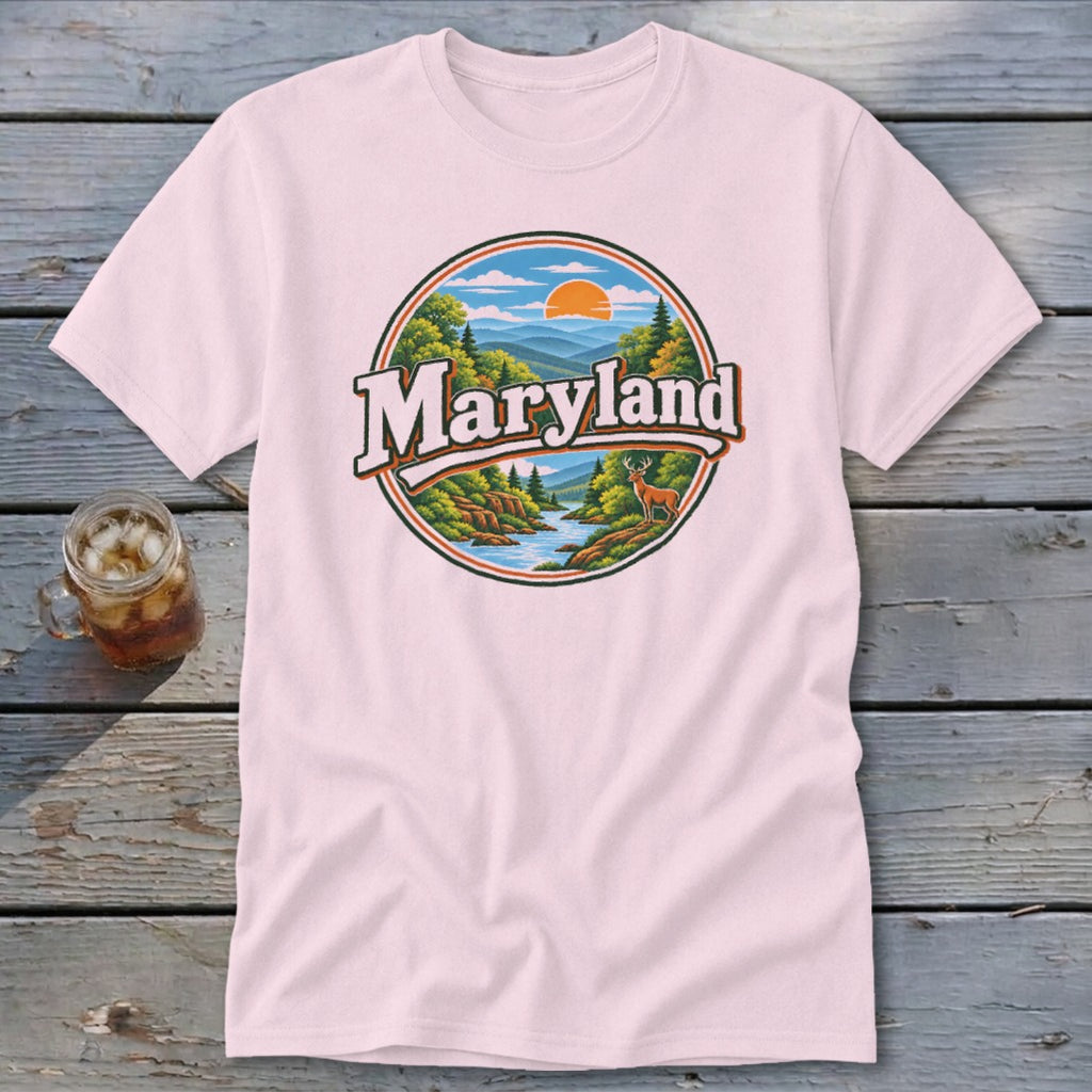 Pink t-shirt with a circular graphic featuring a deer, river, mountains, and the text "Maryland".
