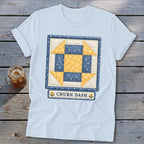 Light blue t-shirt with a Churn Dash quilt block design and text.
