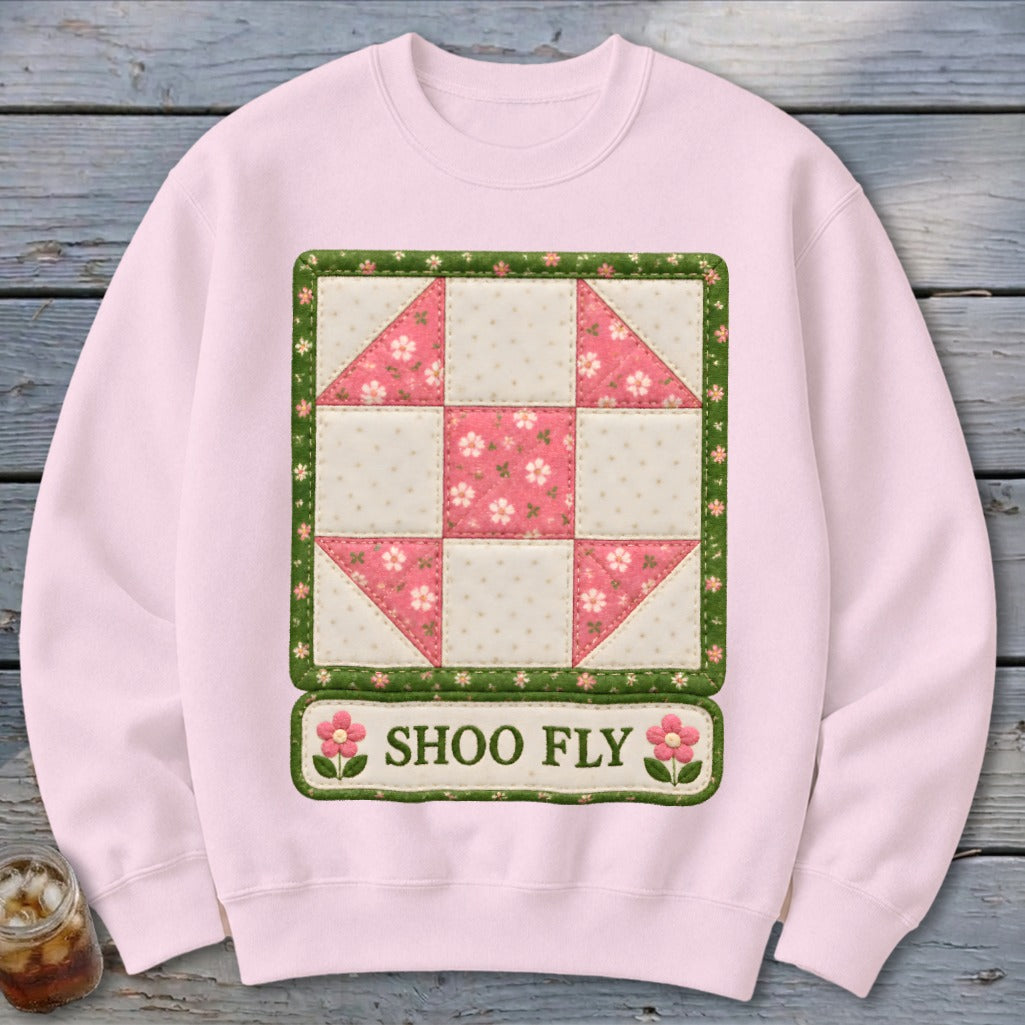 Pink sweatshirt with "Shoo Fly" text and a quilt block design.
