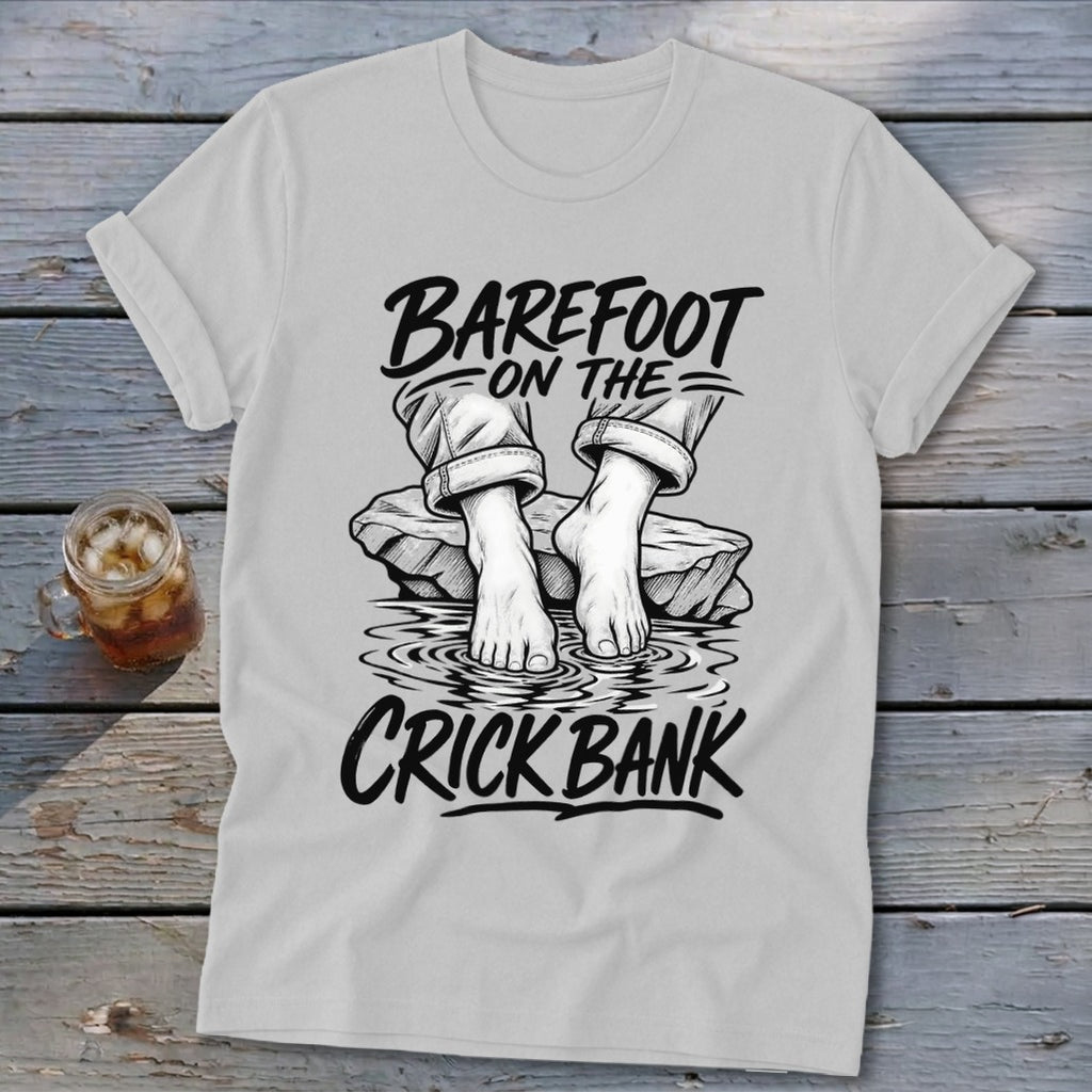T-shirt graphic with text "BAREFOOT ON THE CRICK BANK" and bare feet on rocks.