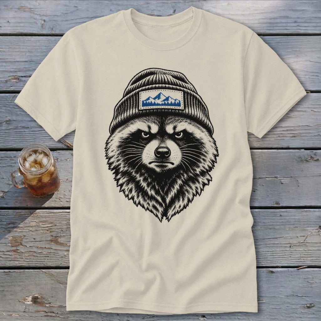 T-shirt with black and white illustration of a raccoon wearing a beanie with mountain patch.