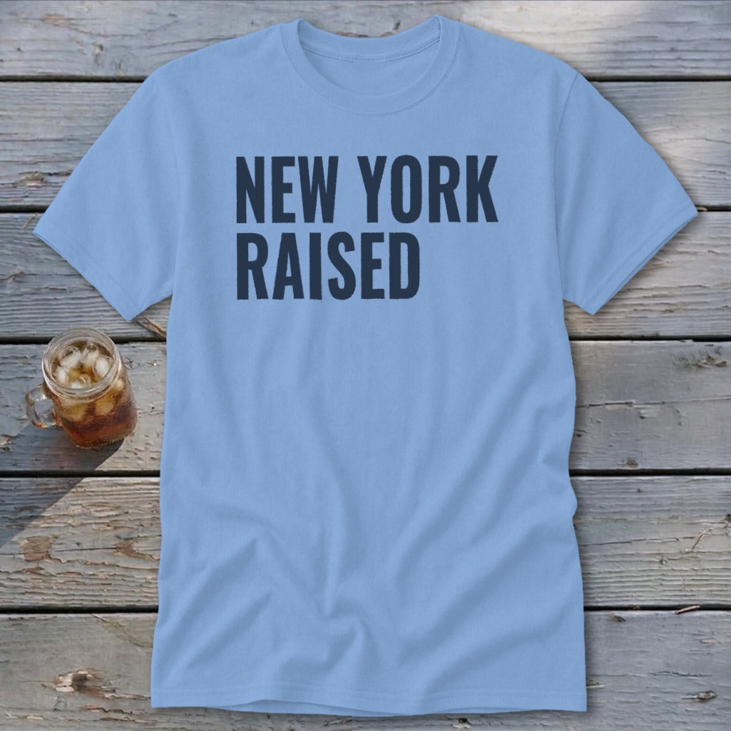 Light blue t-shirt with "NEW YORK RAISED" in dark blue text.