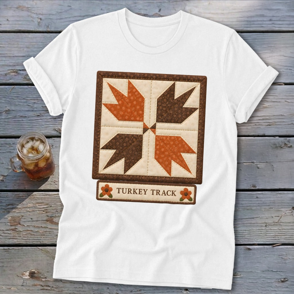 White t-shirt with a "Turkey Track" quilt block design and text.
