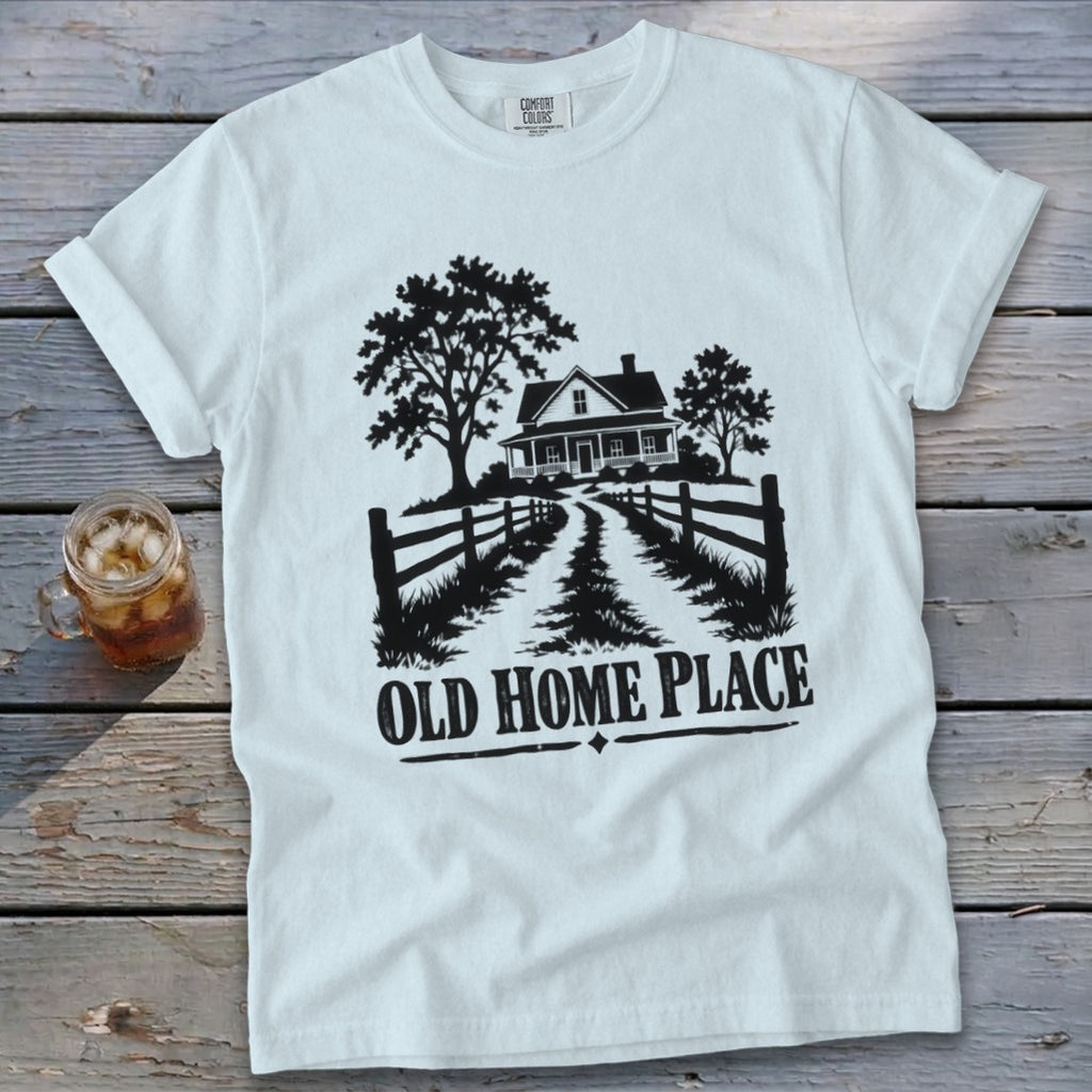 White t-shirt with black graphic of a farmhouse, trees, fence, and the words "Old Home Place".