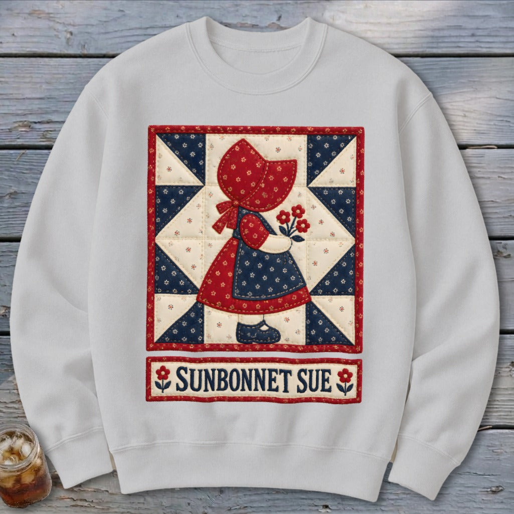 White sweatshirt with Sunbonnet Sue quilt art and text.