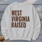 White crewneck sweatshirt with brown text "WEST VIRGINIA RAISED".