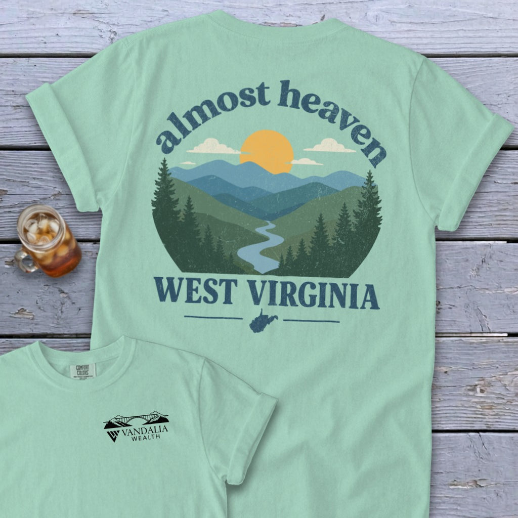 Light blue t-shirt with "almost heaven WEST VIRGINIA" mountainous landscape graphic.