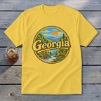 Yellow t-shirt with a circular graphic of a Georgia landscape, river, and deer.