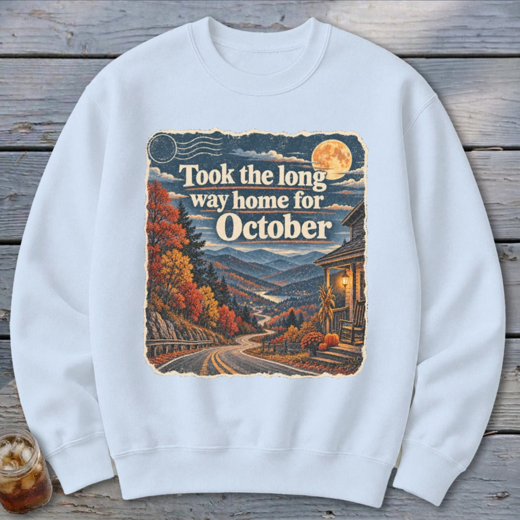 Sweatshirt with fall landscape, winding road, house, and text "Took the long way home for October".