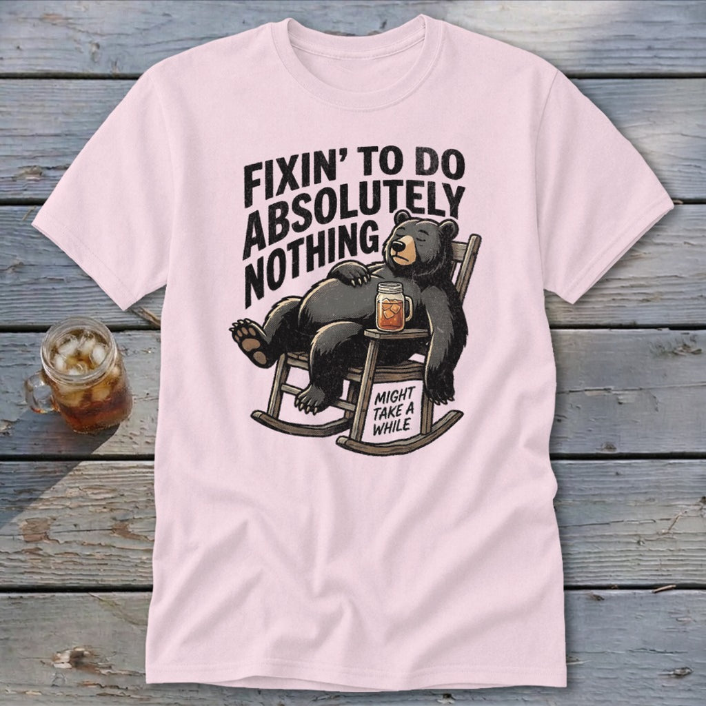 Light pink t-shirt featuring a cartoon bear relaxing in a rocking chair with text.
