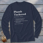 Navy long sleeve shirt with white text defining "Plumb Tucked".