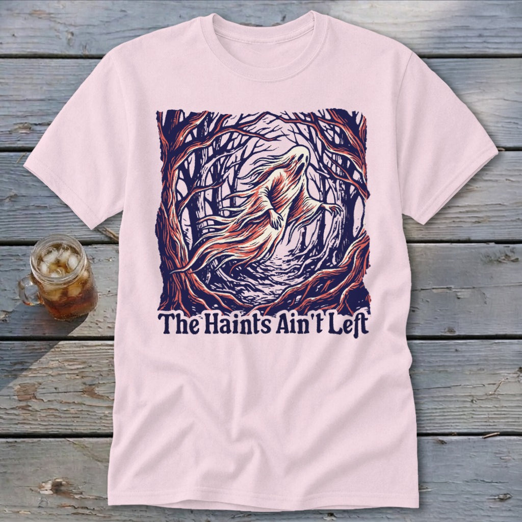 Pink t-shirt with a ghost in a forest and text "The Haints Ain't Left".
