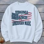 White sweatshirt with "Virginia Raised American Made" text over a distressed American flag.