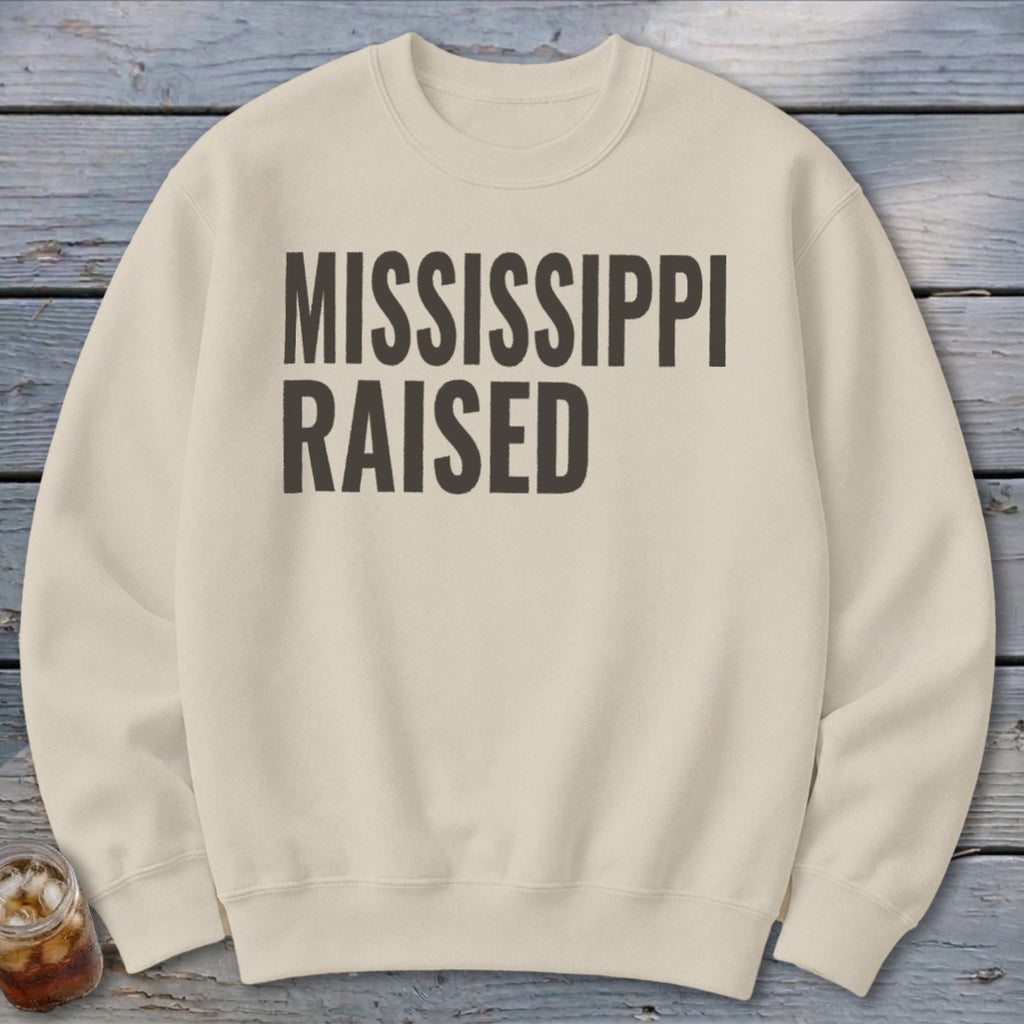 Light cream sweatshirt with "MISSISSIPPI RAISED" text in dark gray.