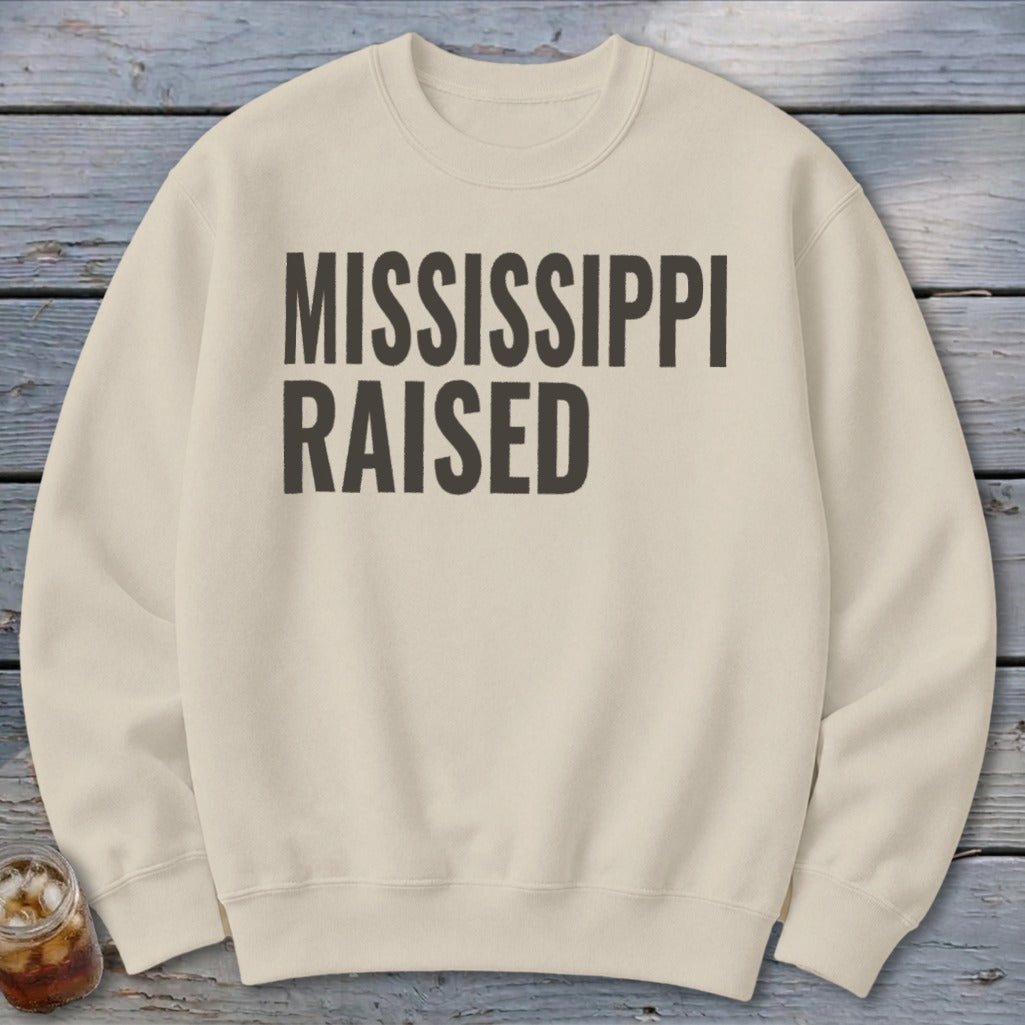 Light cream sweatshirt with "MISSISSIPPI RAISED" text in dark gray.