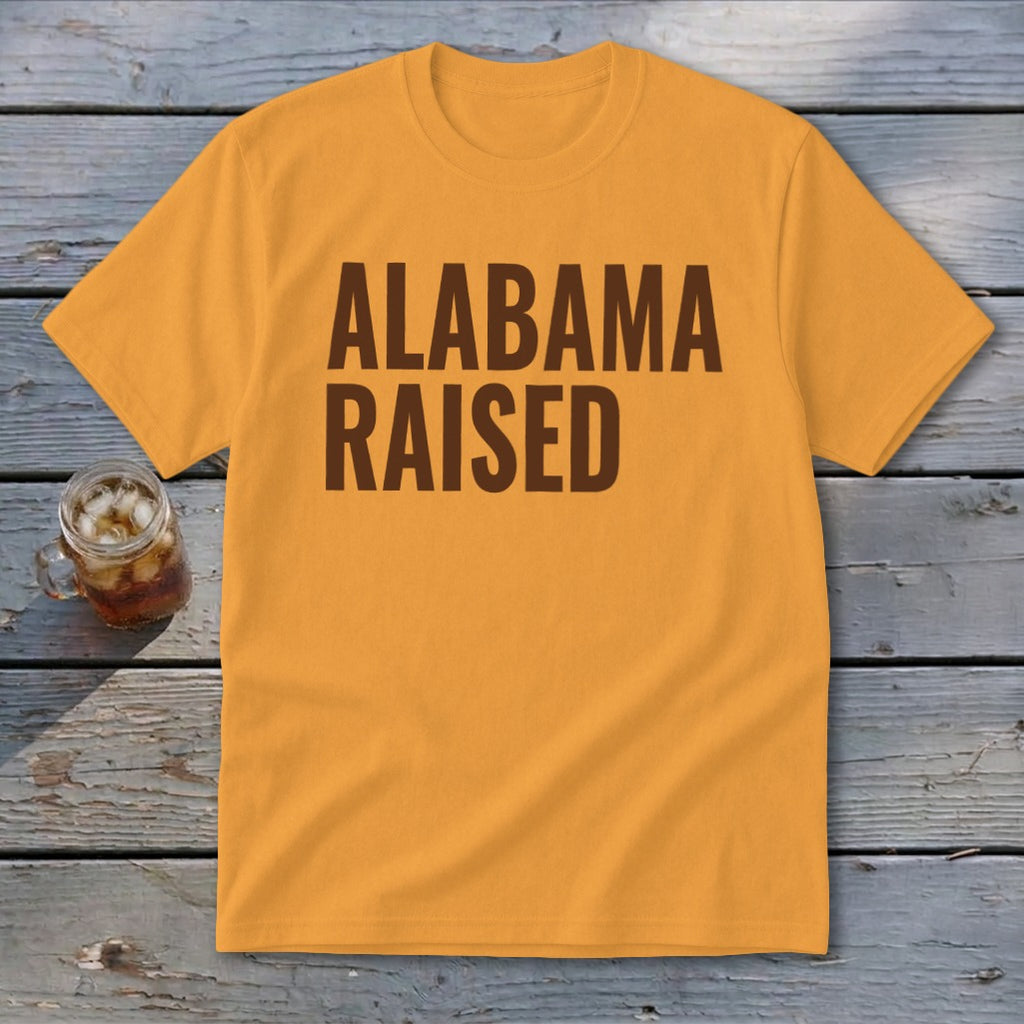 Orange t-shirt with brown text reading "ALABAMA RAISED".