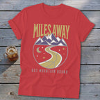 Red t-shirt with "MILES AWAY BUT MOUNTAIN BOUND" text and mountain graphic.